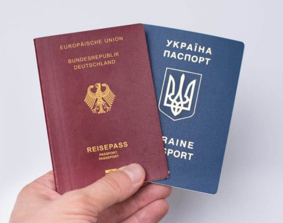 Ukrainian and Russian international passports in the man's hand.