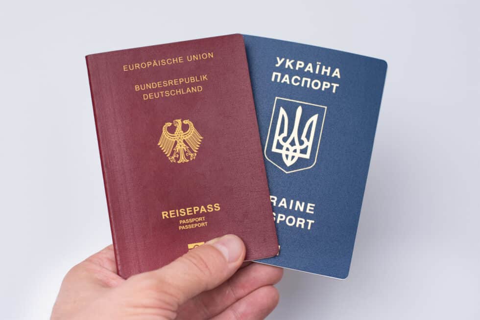 Ukrainian and Russian international passports in the man's hand.